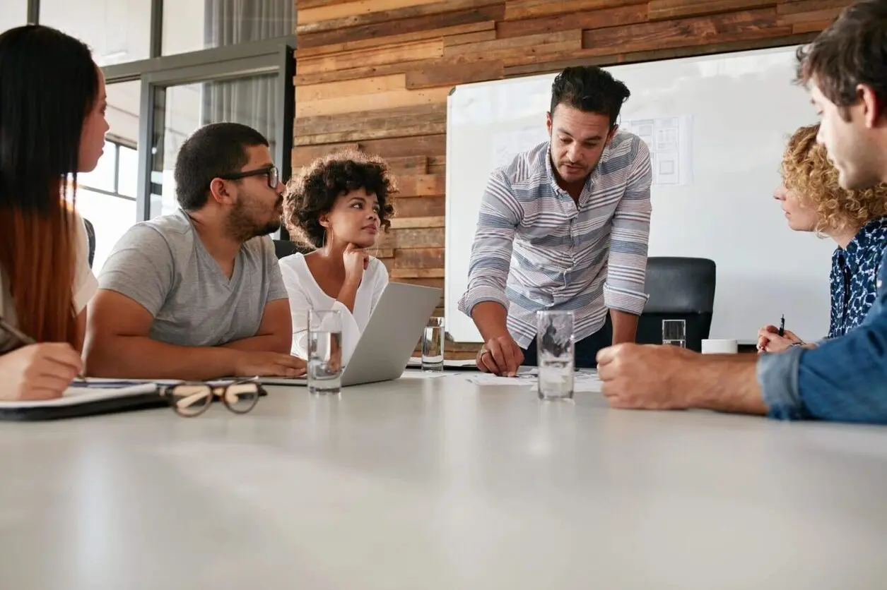 A group of people sitting around a table.